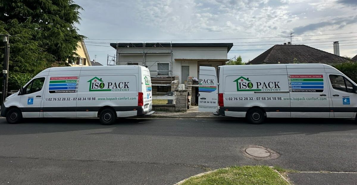 Camions Isopack Confort devant un chantier d'isolation par l'extérieur près de Rouen